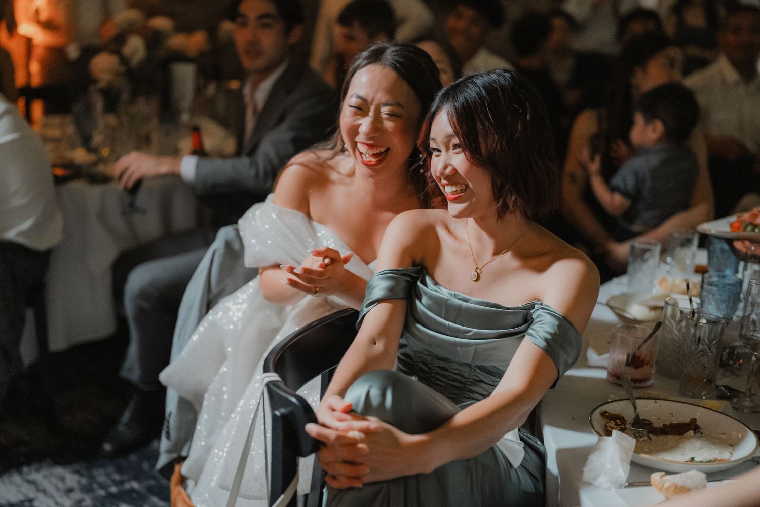 Wedding reception guests share joyful moments while dancing in an atmospheric venue setting.