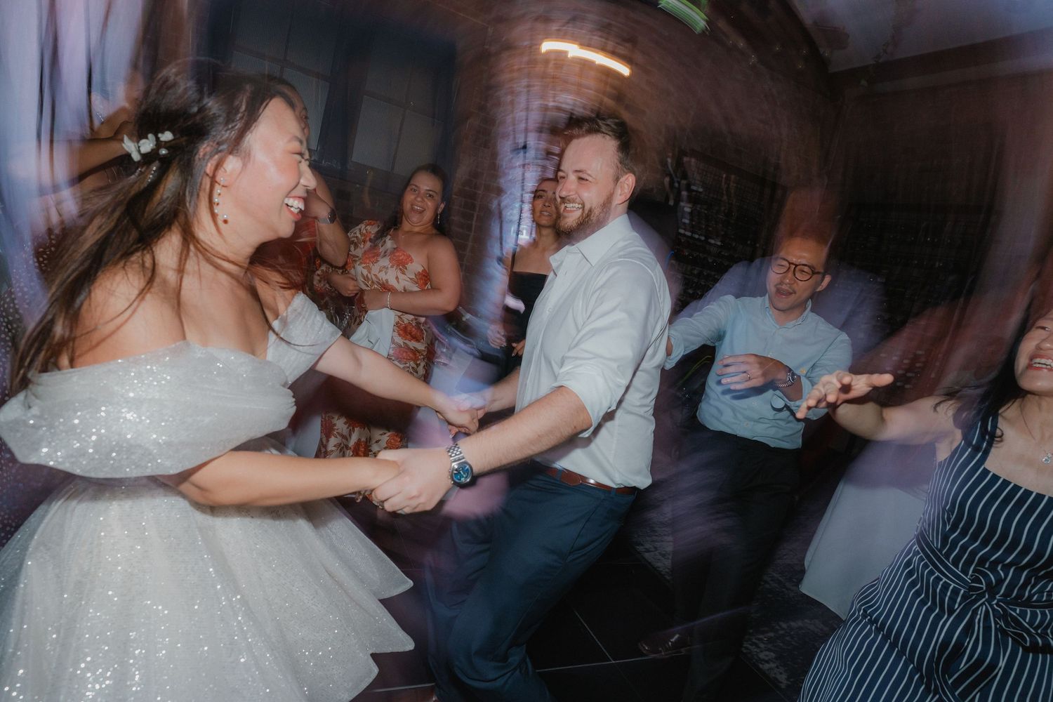 Wedding reception dance floor fills with guests enjoying upbeat celebration music.