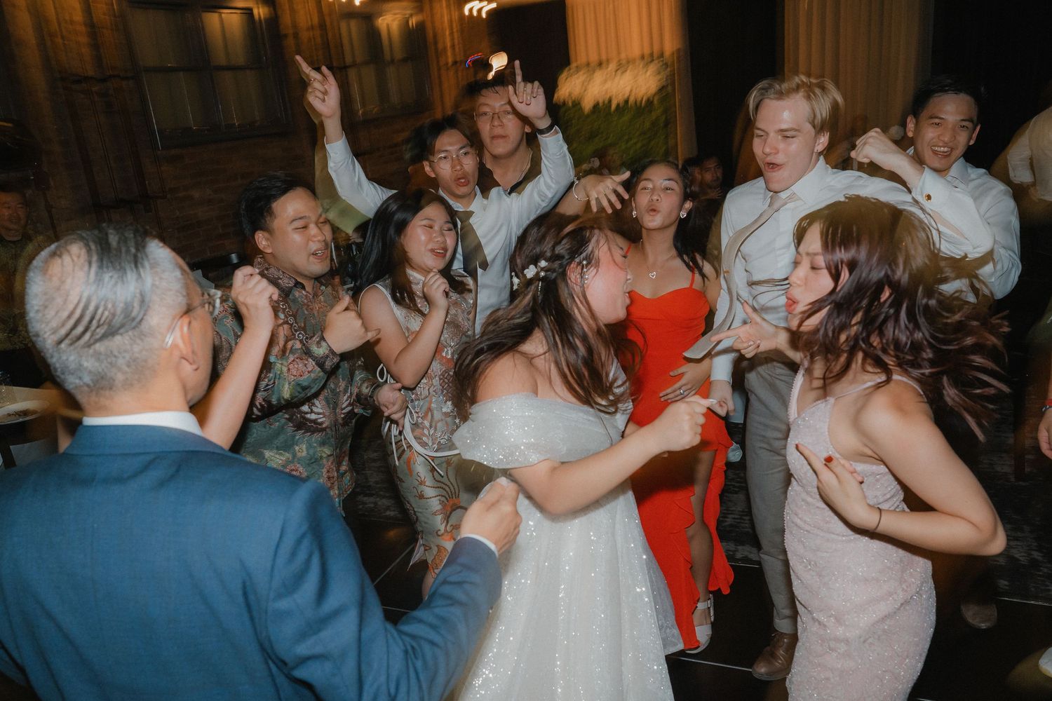 Party-goers create a lively dancing circle during an evening celebration.