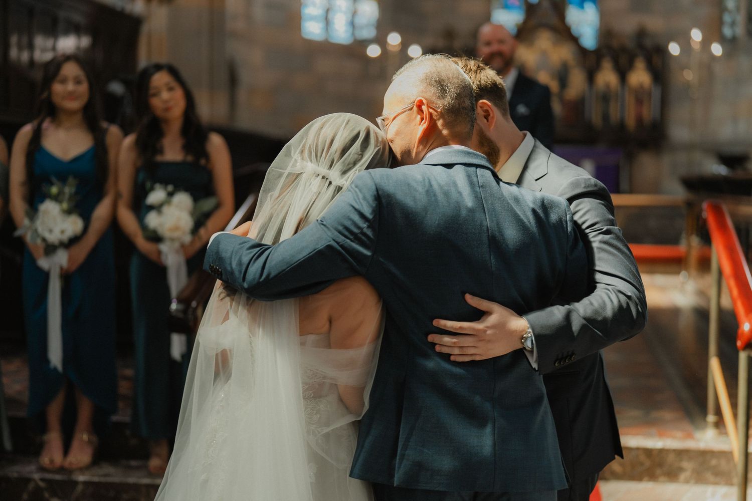 Emotional moment during a wedding ceremony in a gothic church interior.