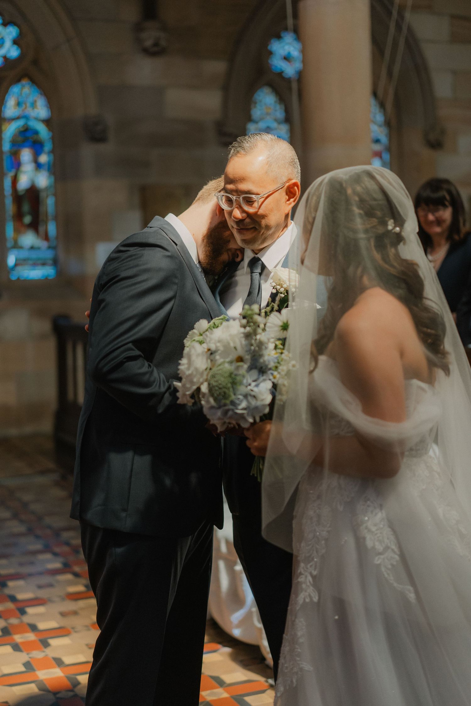 Emotional moment captured during wedding ceremony in church setting.