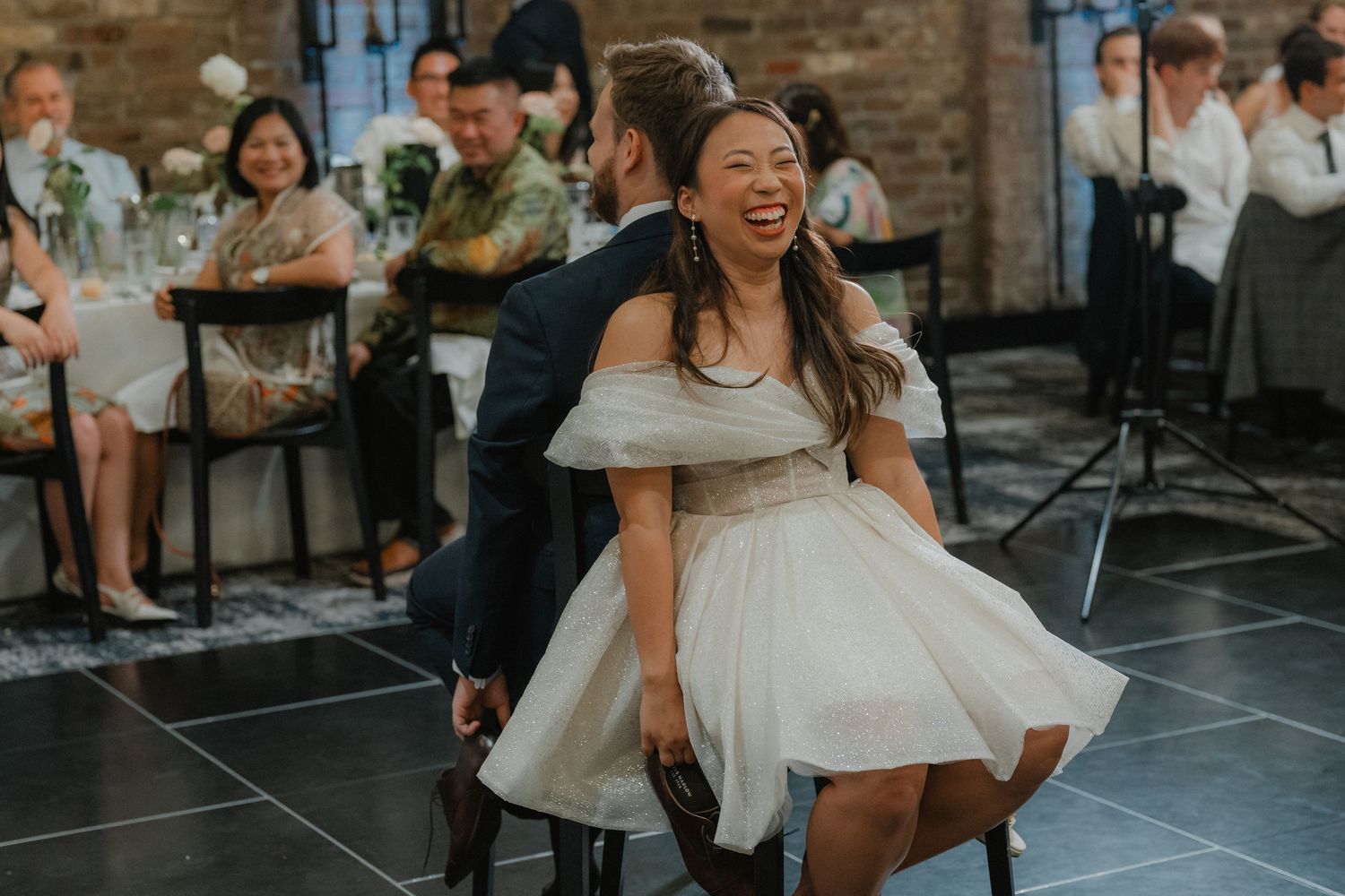 Wedding reception candid moment of dancing in a modern industrial venue space.