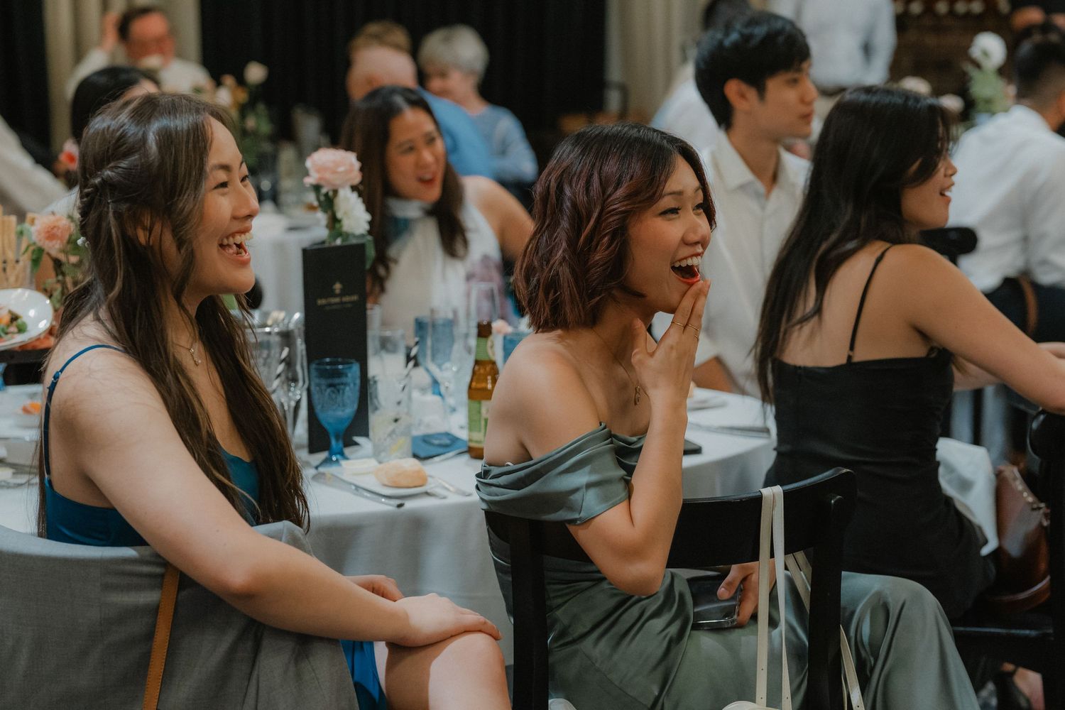 Candid reception moment with guests enjoying the celebration at decorated tables.