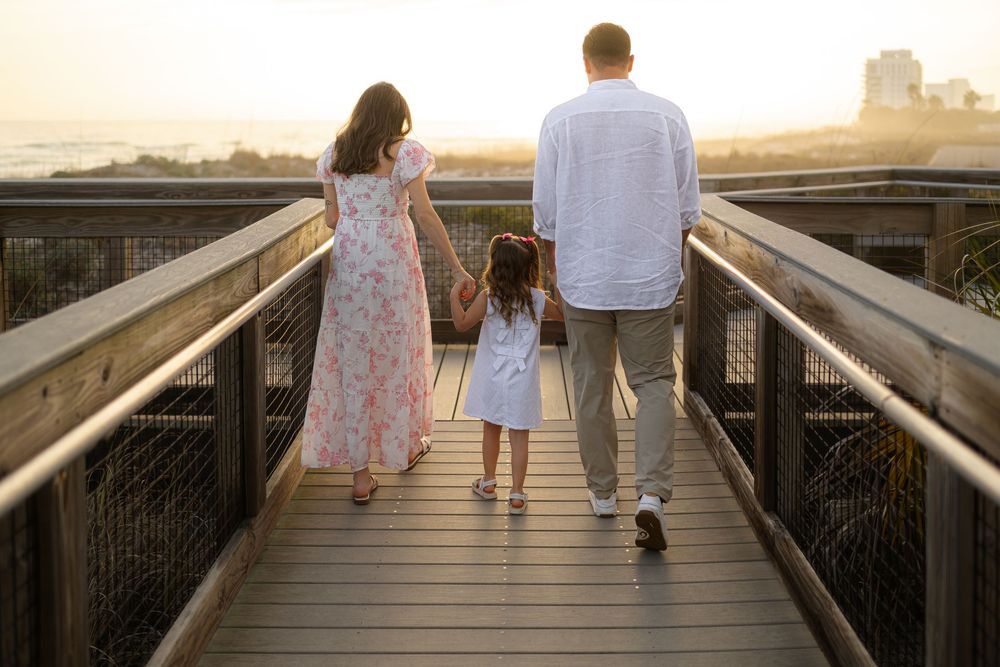 Friendly professional sunset photographer wooden boardwalk toward a sunset beach view. Best beaches for families to visit while on vacation