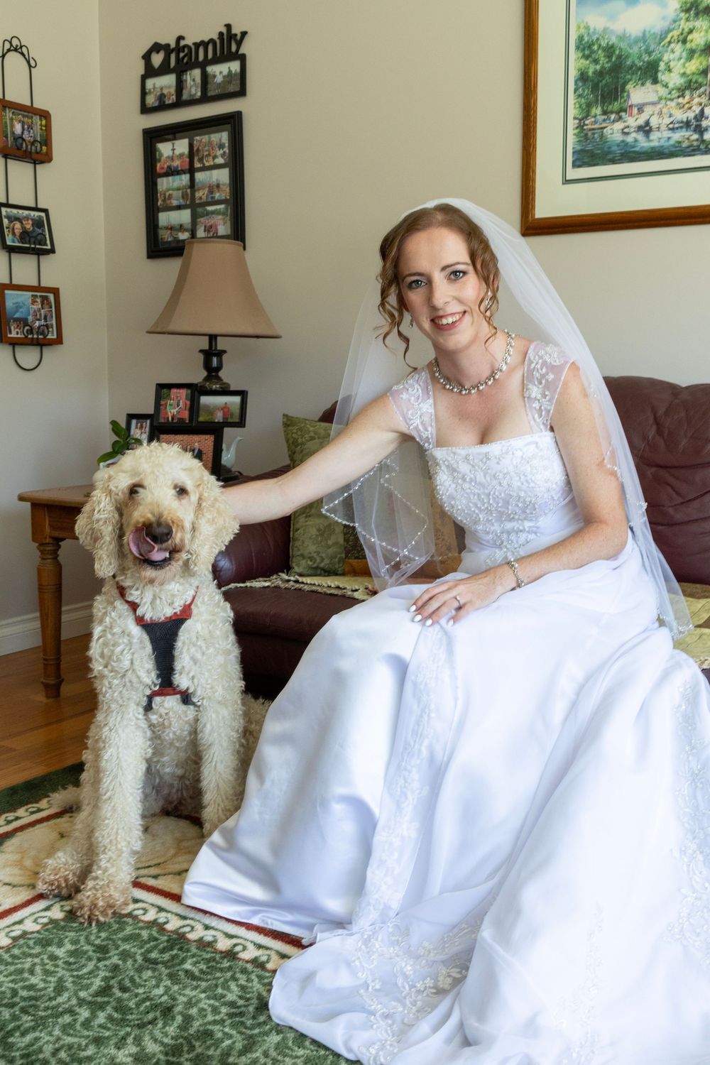 A bridal portrait with her dog sitting next to her in their family home.