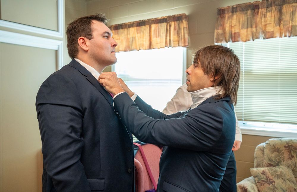 Best man straightening the tie of a groom before the ceremony at Maranatha Christian Reformed Church in Bowmanville.