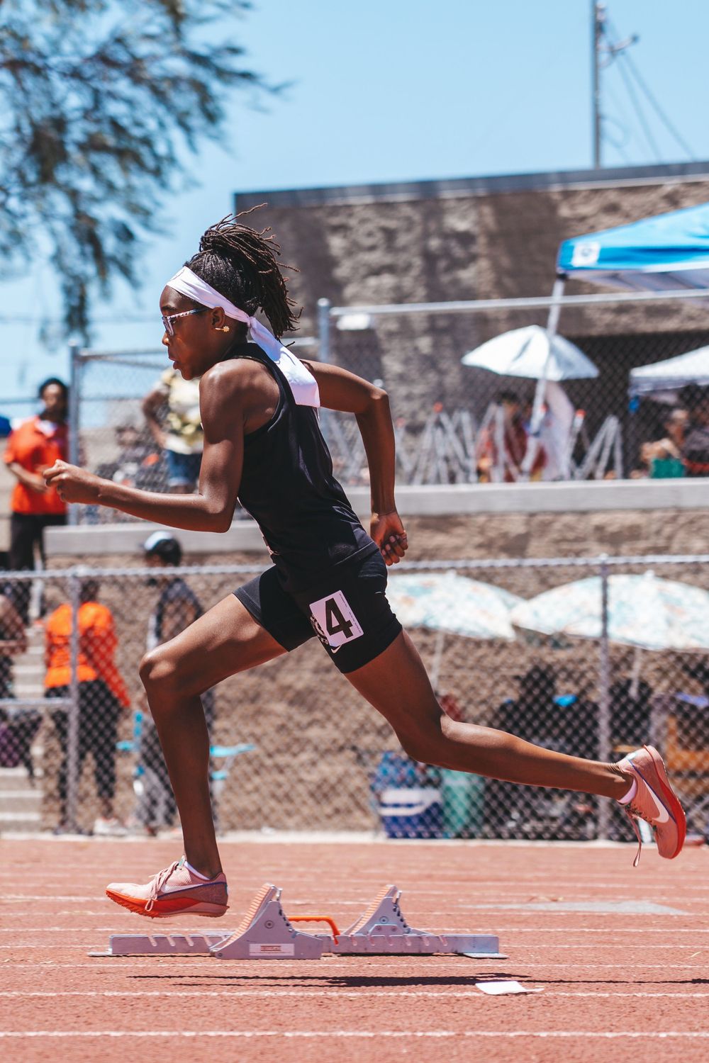 Track athlete sprinting off starting blocks during race.