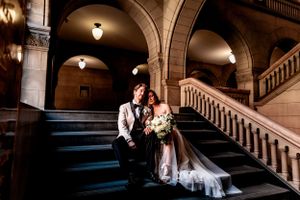 newlyweds cuddle on Allegheny County Courthouse stairs