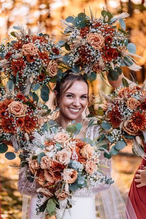 bouquet circles laughing bride at fall golden hour wedding at The Barn at Everthine