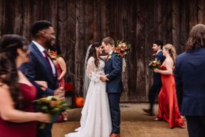 motion blur of wedding party circling kissing newlyweds