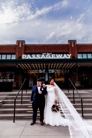 Wedding couple poses together in front of an industrial brick building with PASSAGEWAY signage shown in multiple angles.