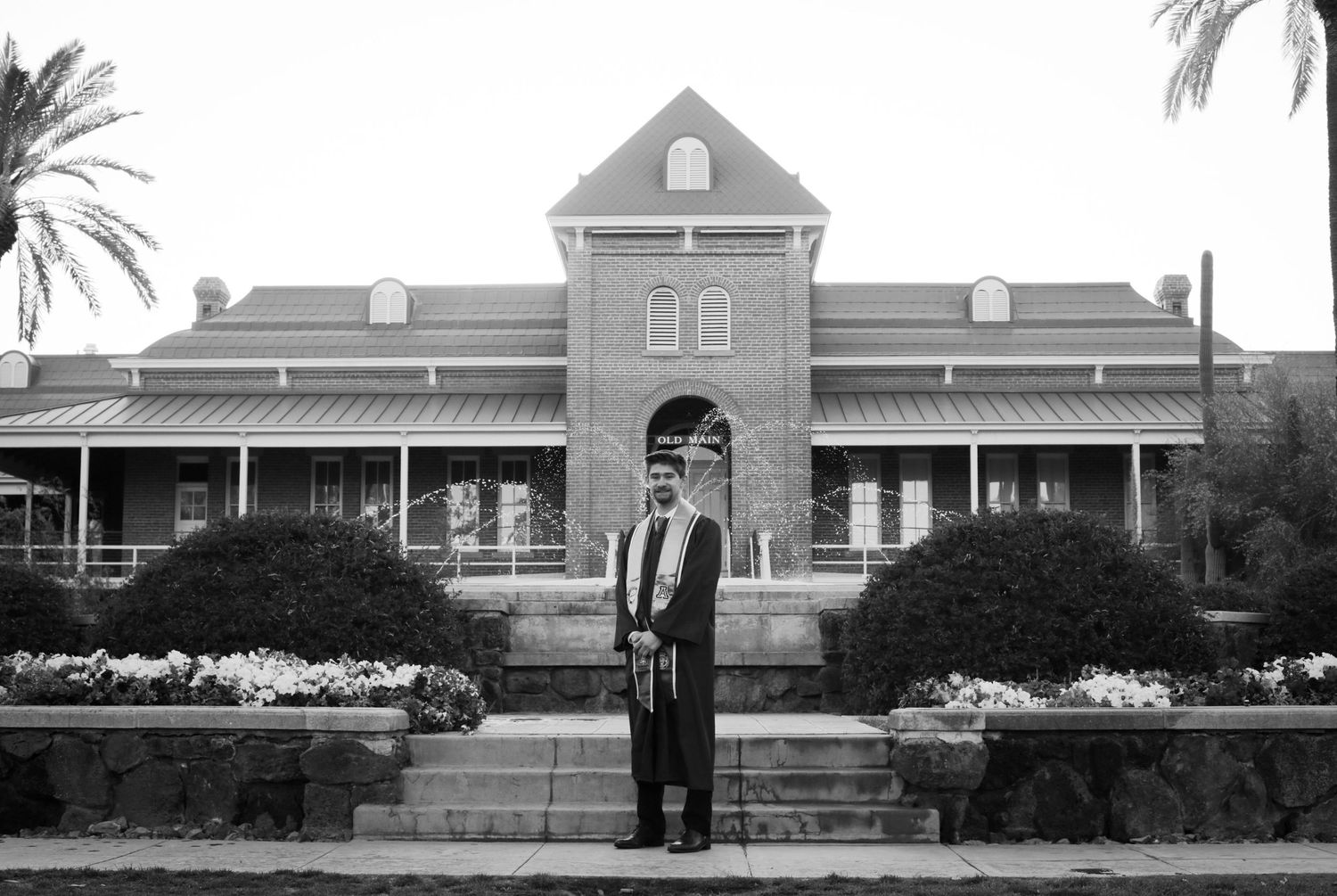 College grad photo in front of Old Main at the University of Arizona
