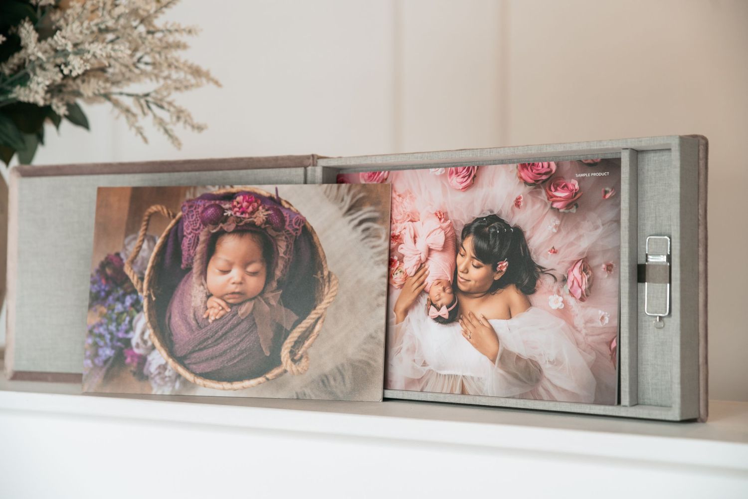Studio wall display featuring professional portrait prints and decorative elements.