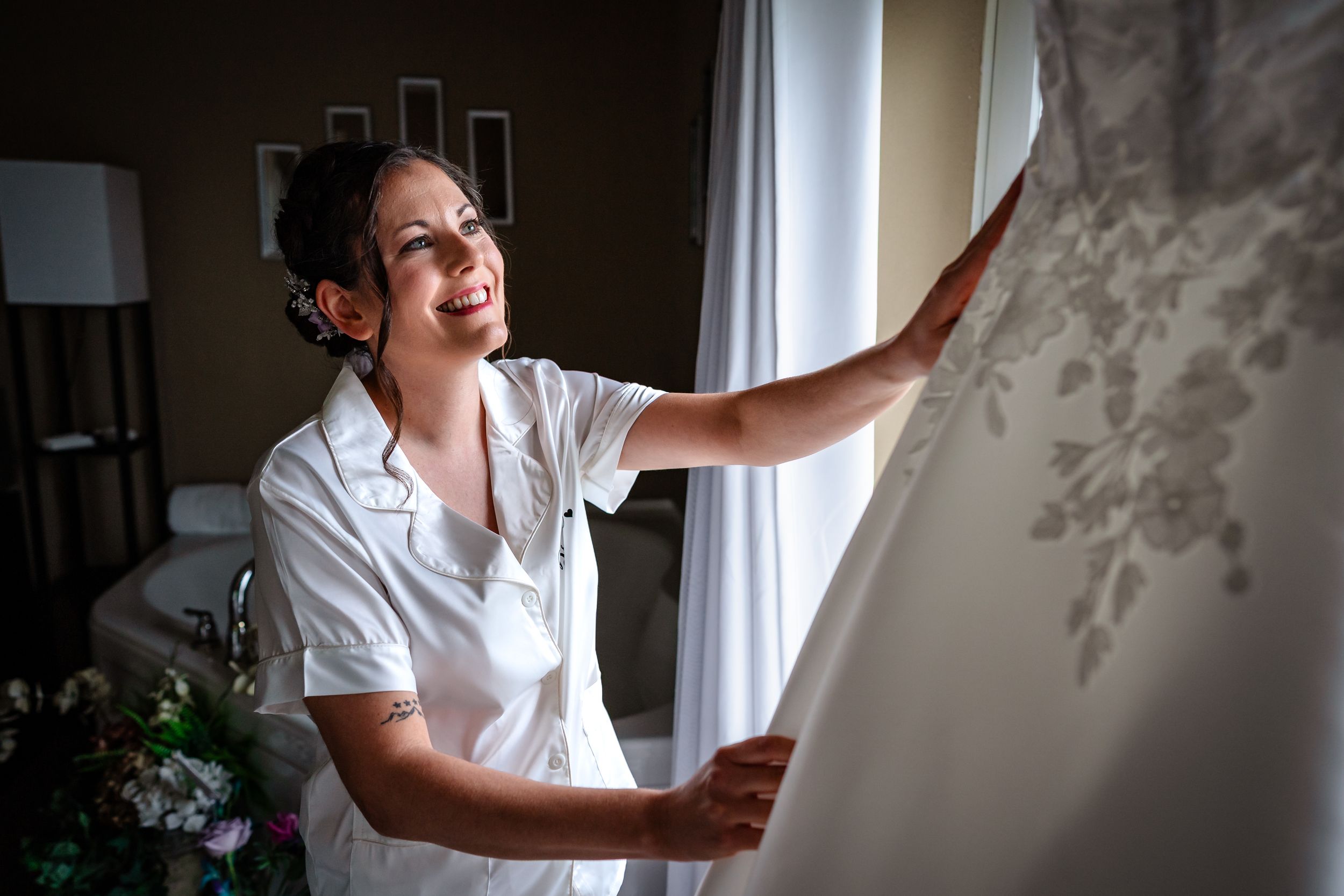 Getting ready moments captured in a bright room with window light.