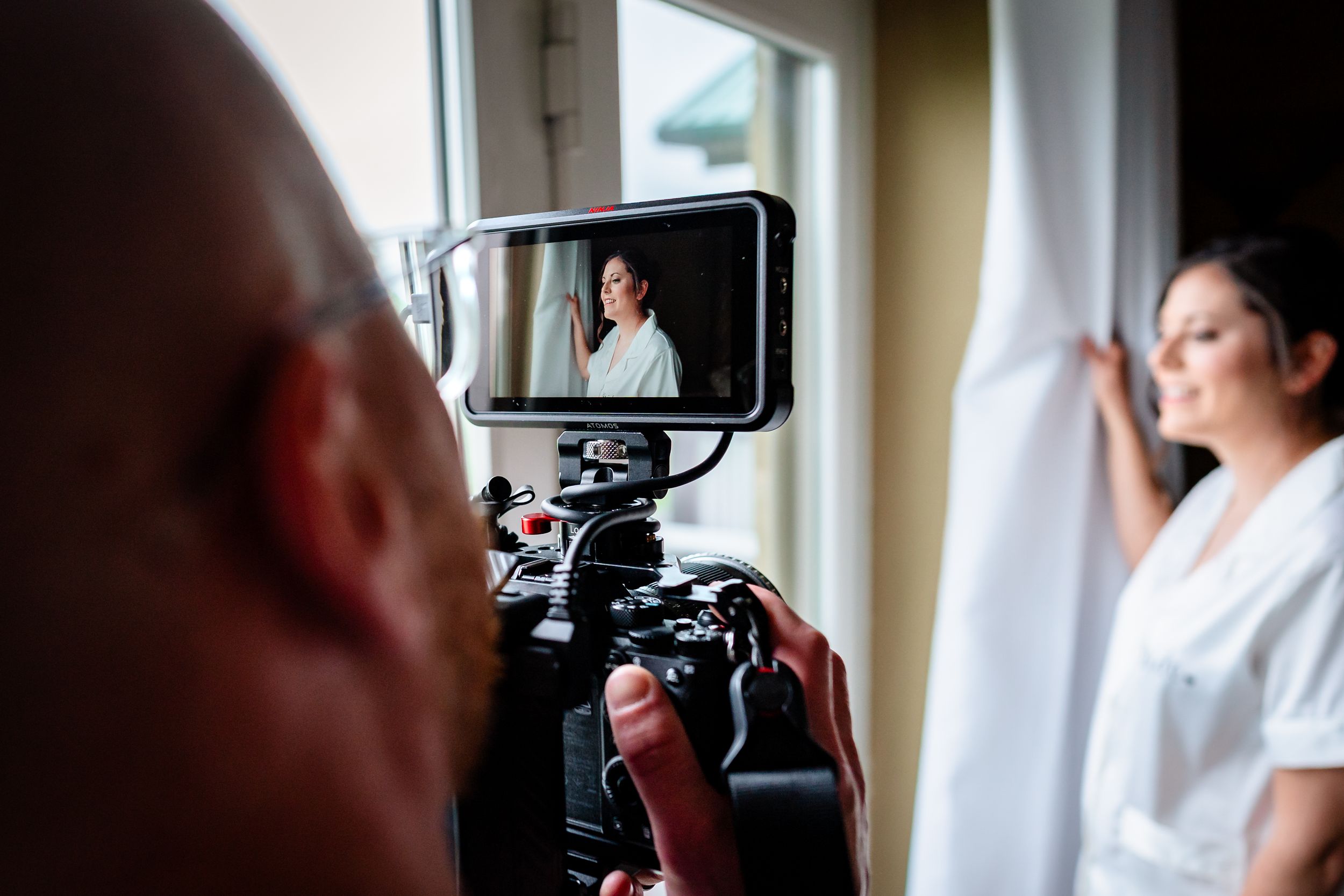 Wedding photography setup with camera equipment in a sunlit room.