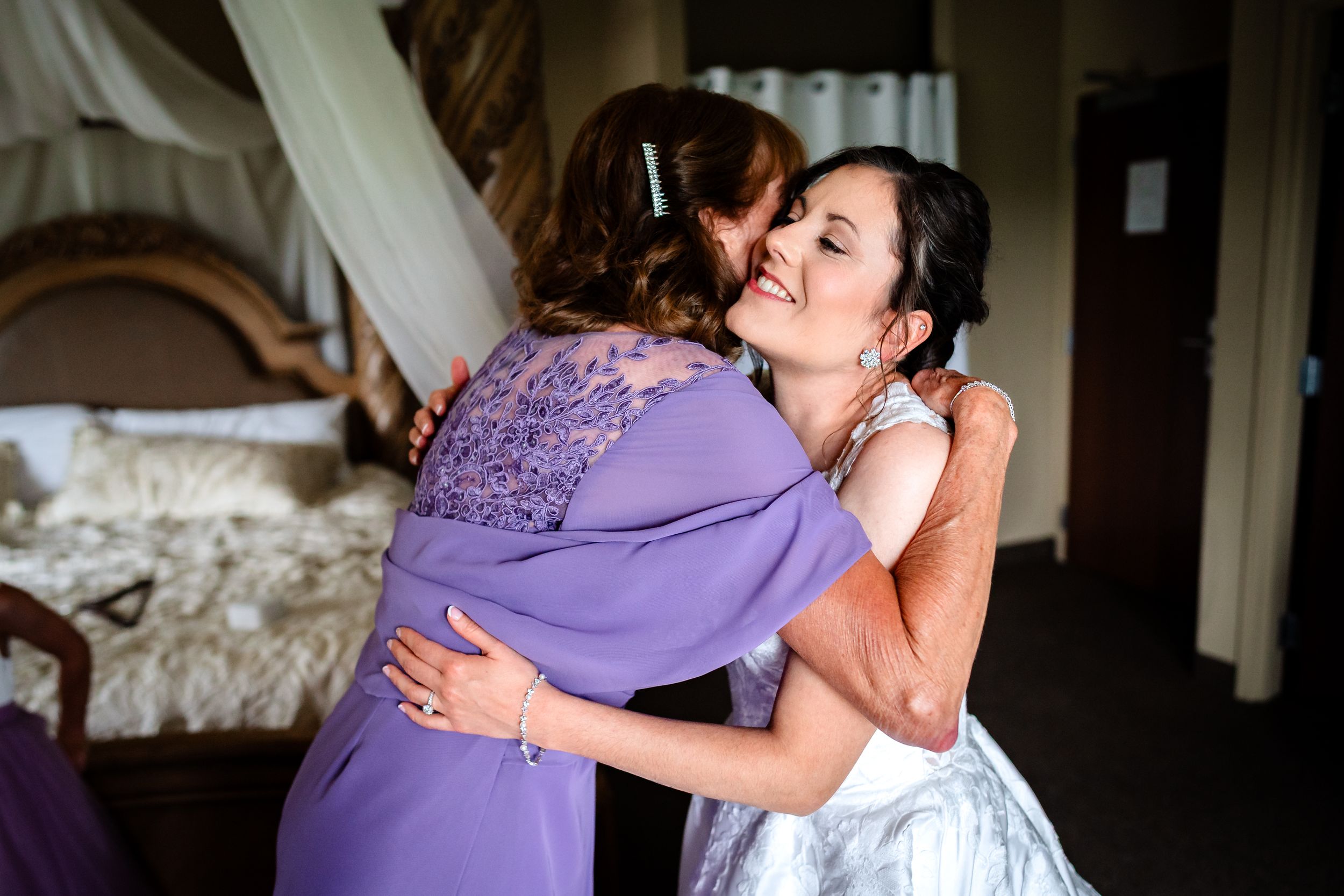 Emotional wedding day moments shared between bride and attendants.