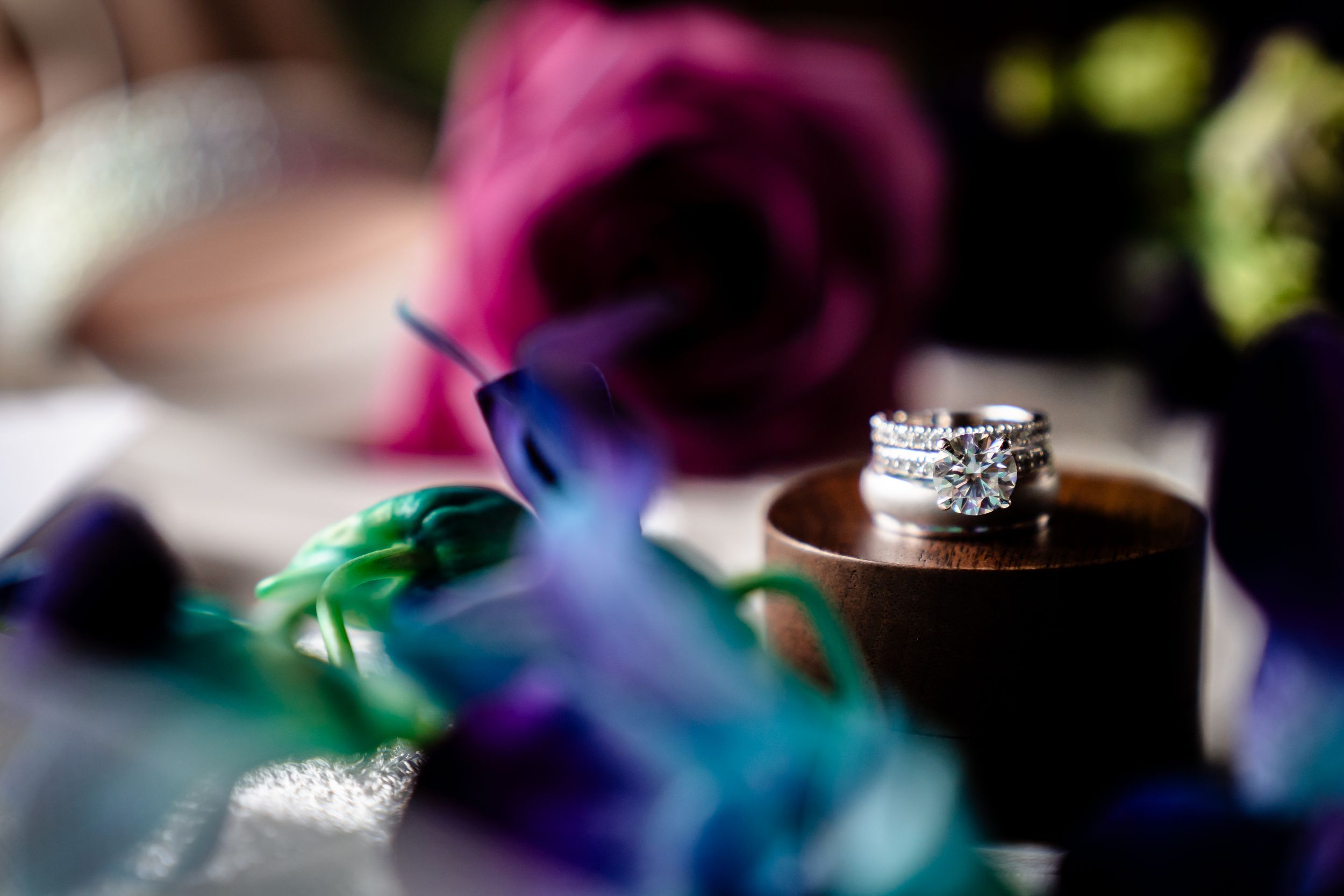 Wedding rings and colorful flowers arranged with delicate details for wedding photography.