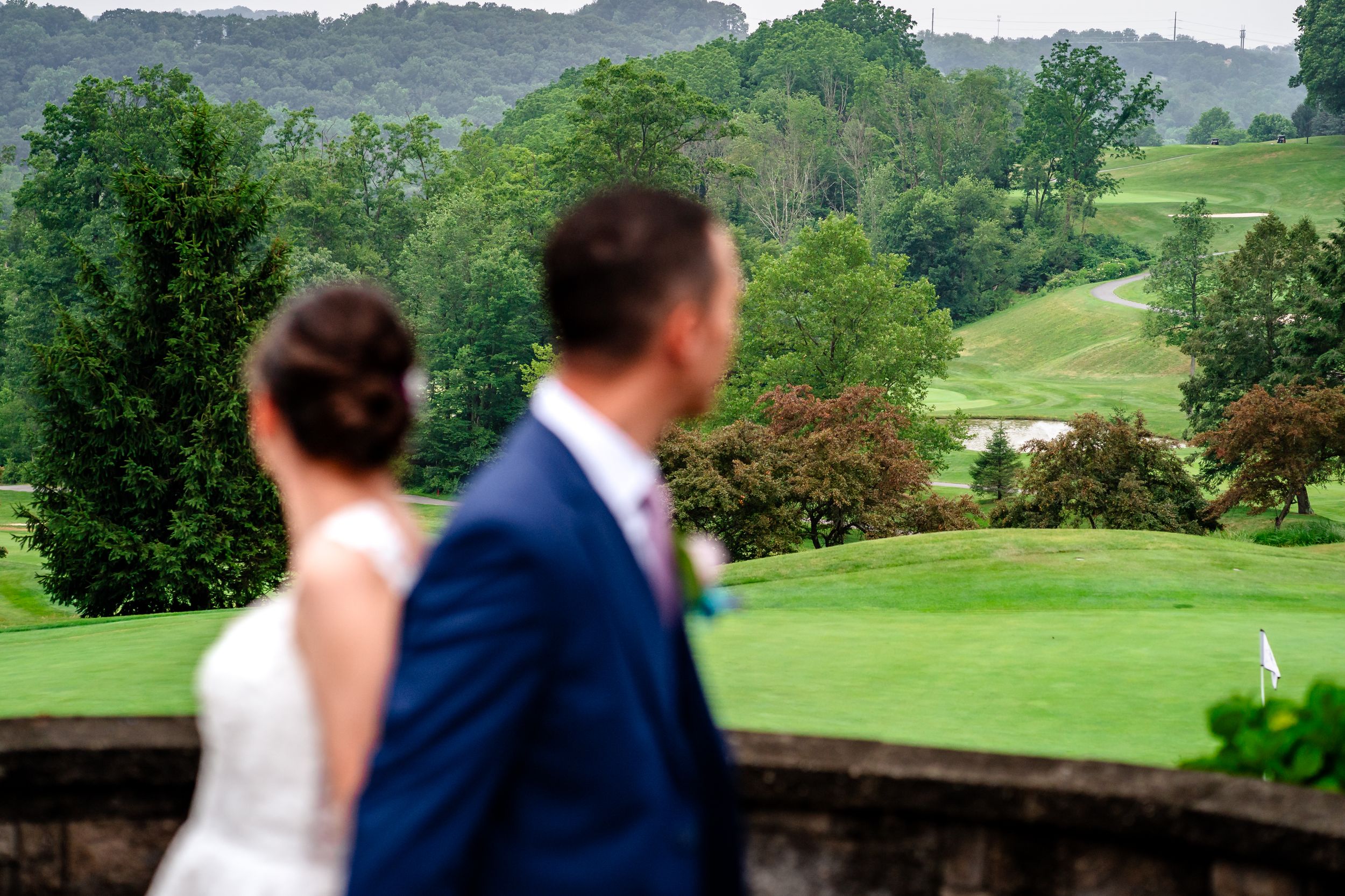 Wedding ceremony setup on a beautiful golf course with rolling hills in the background.