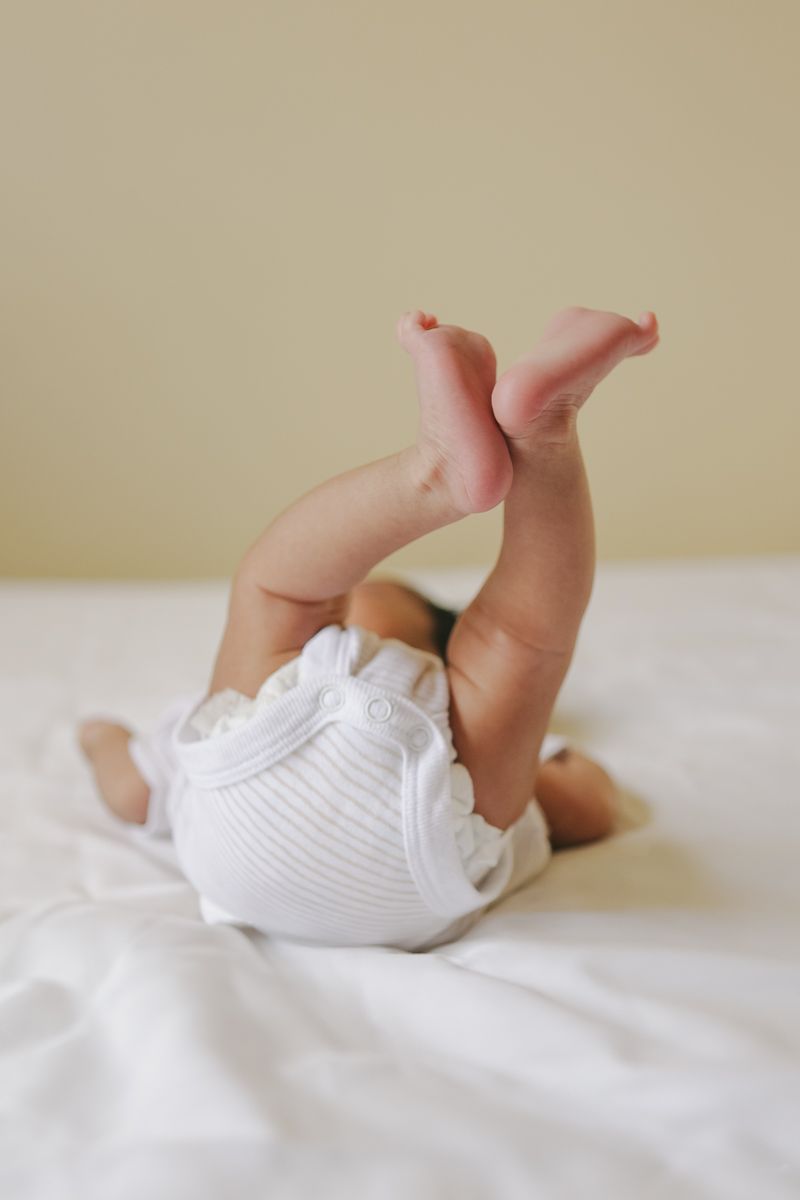 Close-up of newborn baby’s legs stretching during in-home NYC session