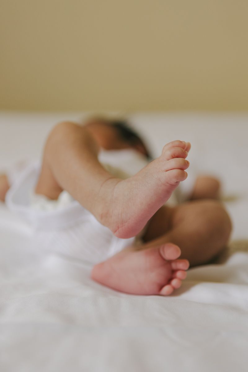 Newborn baby’s tiny feet detail during intimate at-home session in NYC