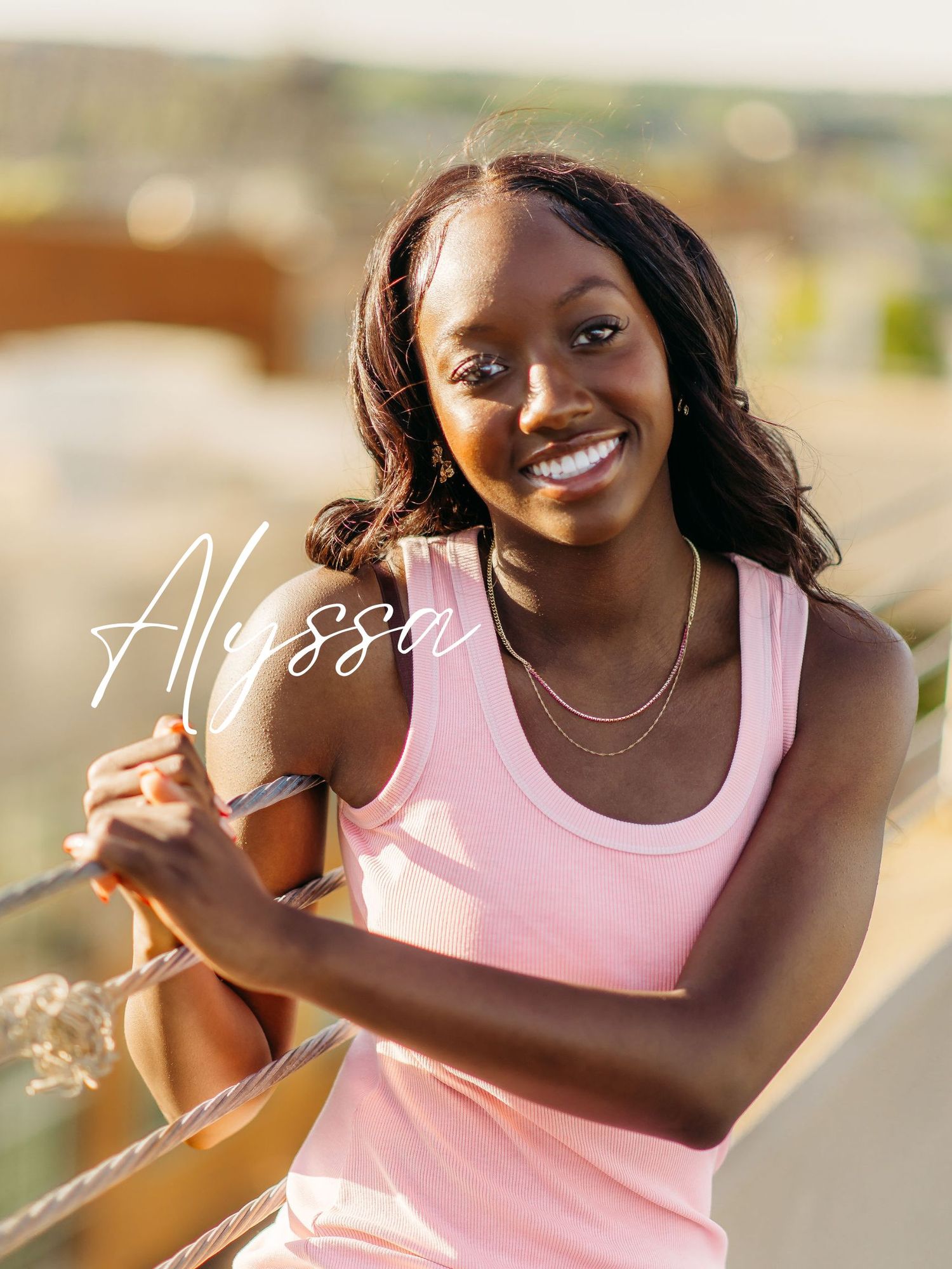 Athletes in pink tank tops enjoying an energetic outdoor workout session against a sunlit natural backdrop.