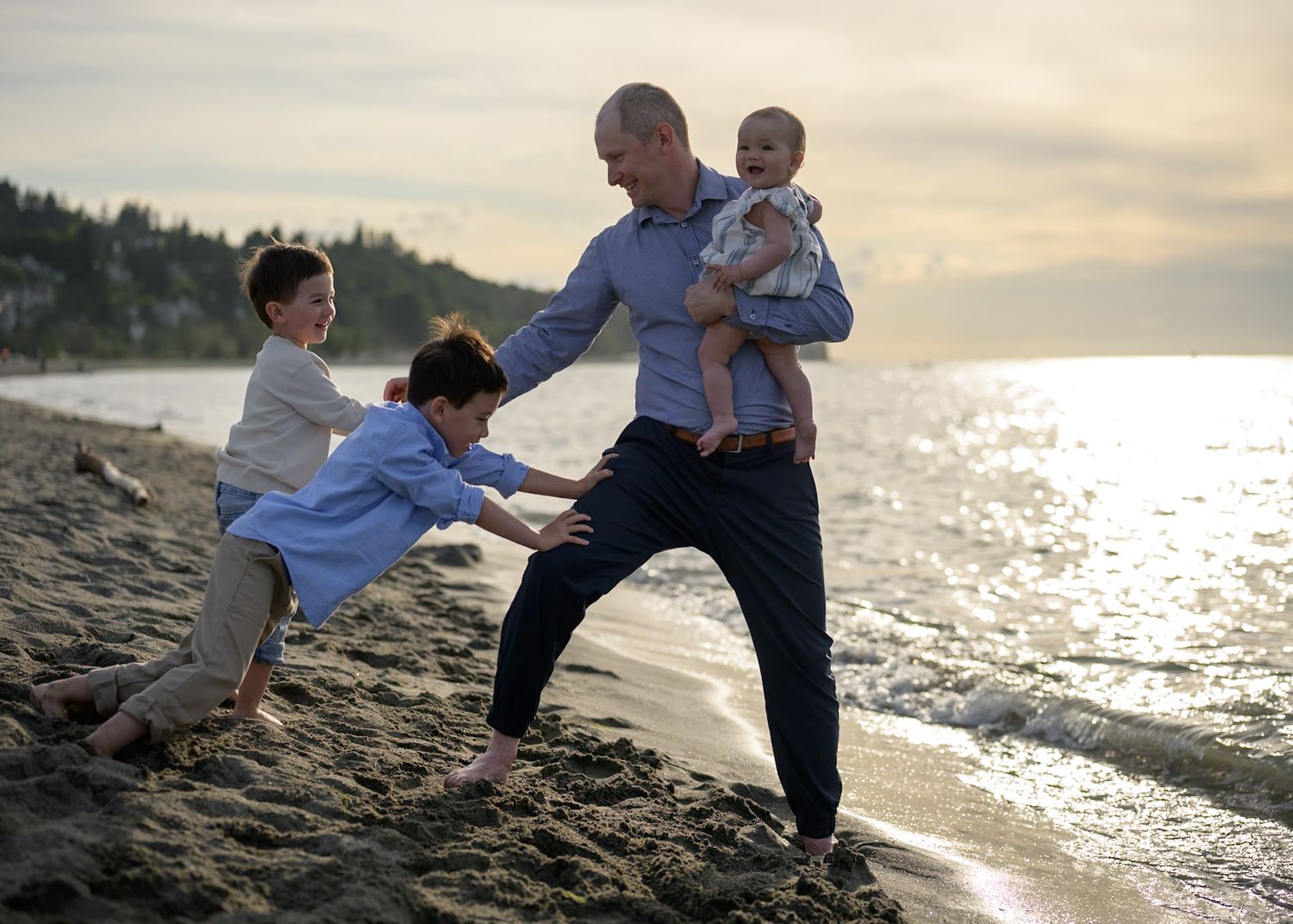 Dad and his children having family fun in the sunshine at Jericho Beach Vancouver family photo session