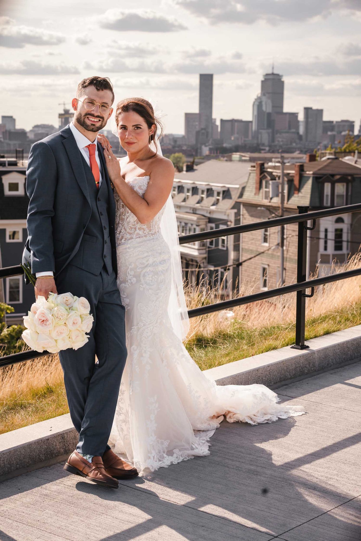 Bride and groom smiling together during romantic wedding portraits at Dorchester Heights in South Boston