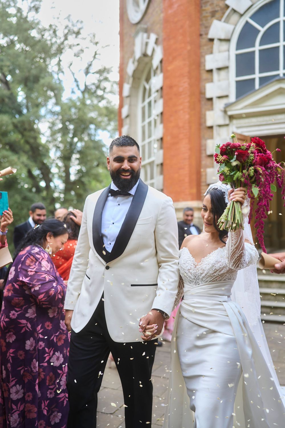 Cinematic bride and groom walk outside the historic Orleans House Gallery