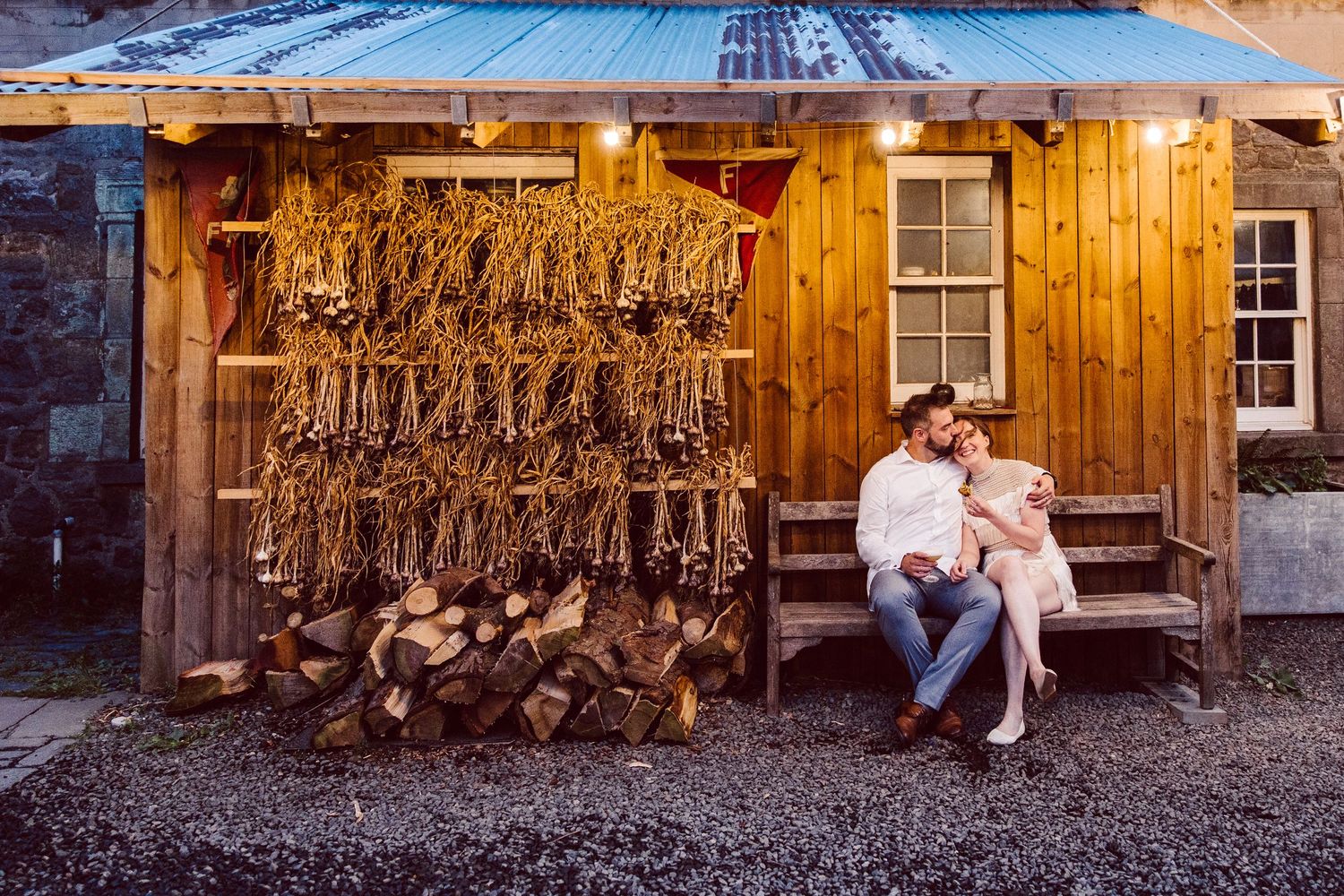 Rustic barn wedding venue with wooden walls and decorative string lights creating a warm, romantic atmosphere.
