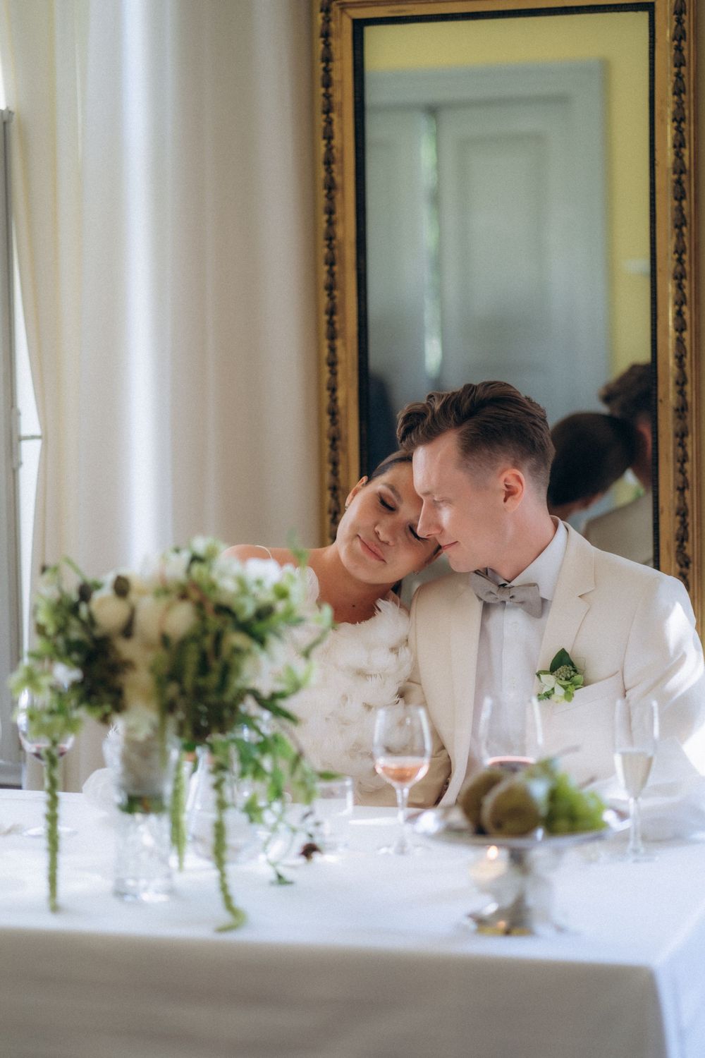 bride and groom sharing quiet moment at reception table elegant wedding dinner Espoon Kartano Finland