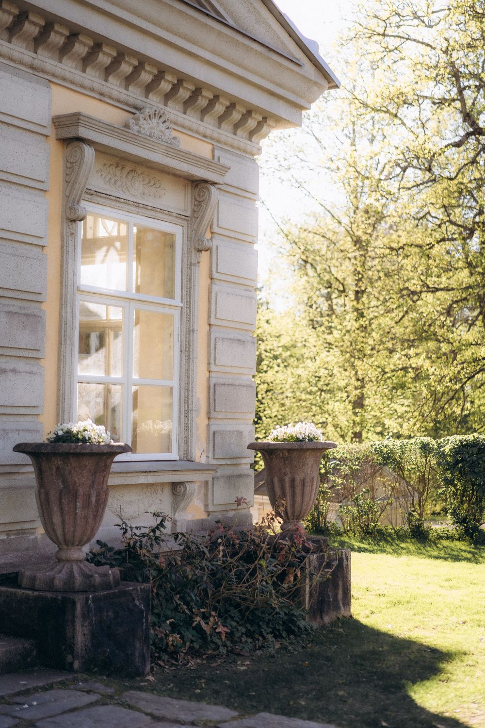 historic manor building exterior in warm sunlight Espoon Kartano wedding venue Finland