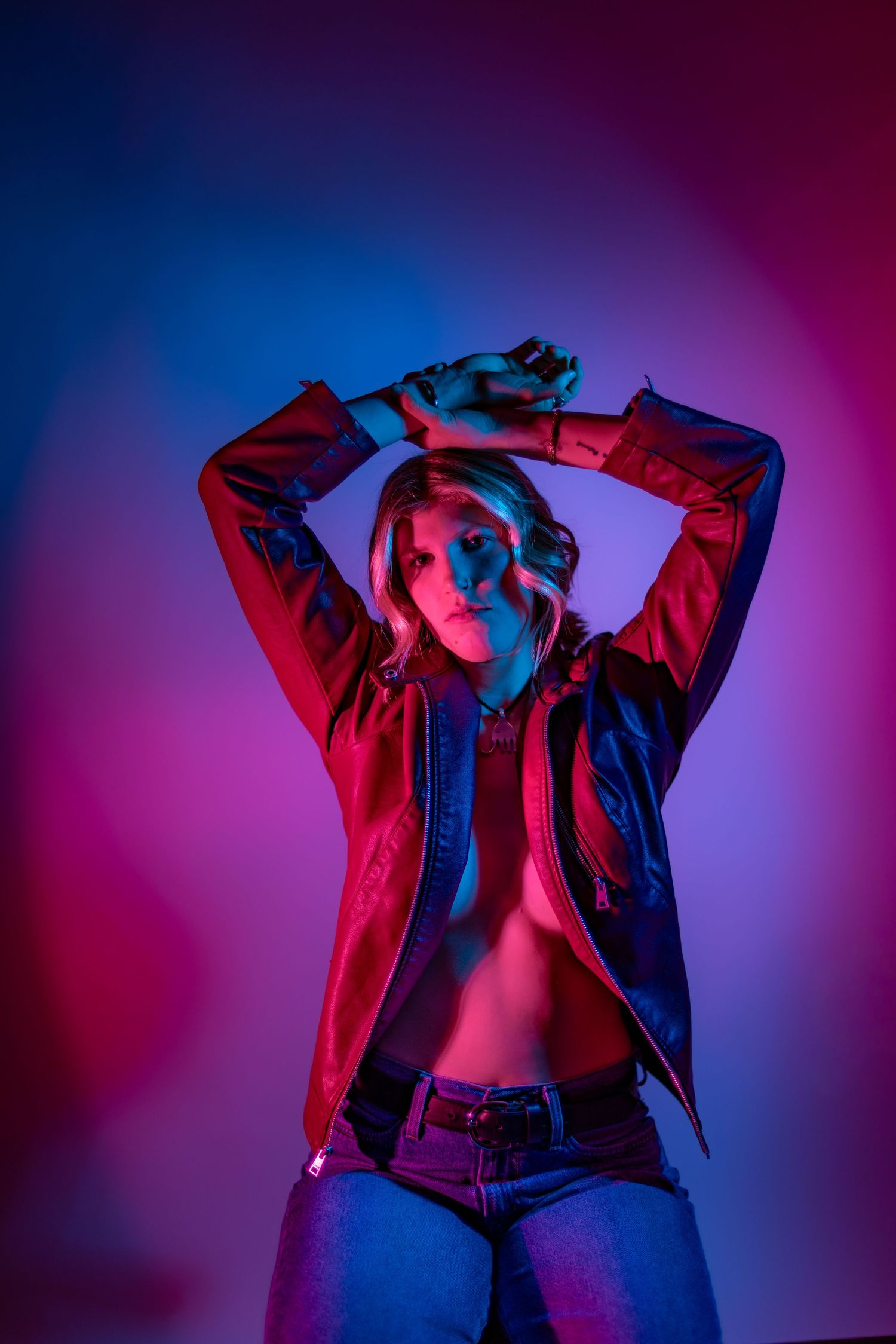 Artistic photo sequence showing person in red jacket against blue and purple gradient background with dramatic lighting.