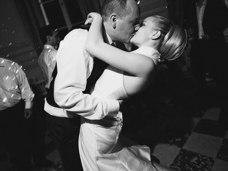 Bride and groom kissing during their wedding reception at Château de Santeny near Paris