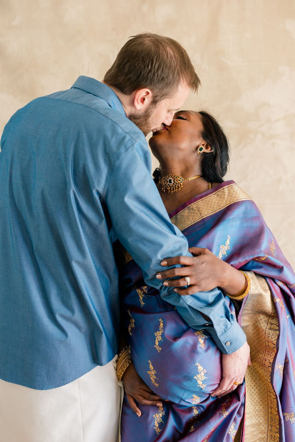 A romantic couple in blue and purple attire share an intimate moment in a series of progressive photographs.