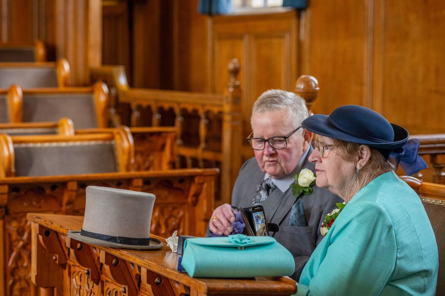 Wide shot – signing the register
Bride and groom signing the register at Southport Town Hall wedding in Sefton, guests watching quietly