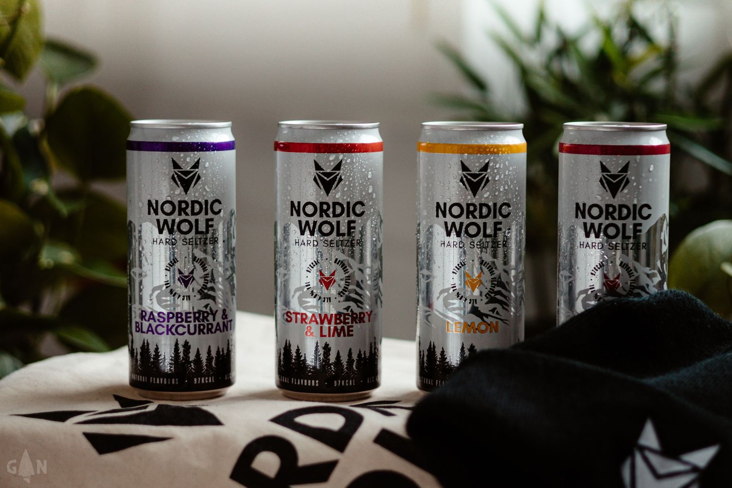 Collection of Nordic Wolf branded candles displayed in black and white packaging.