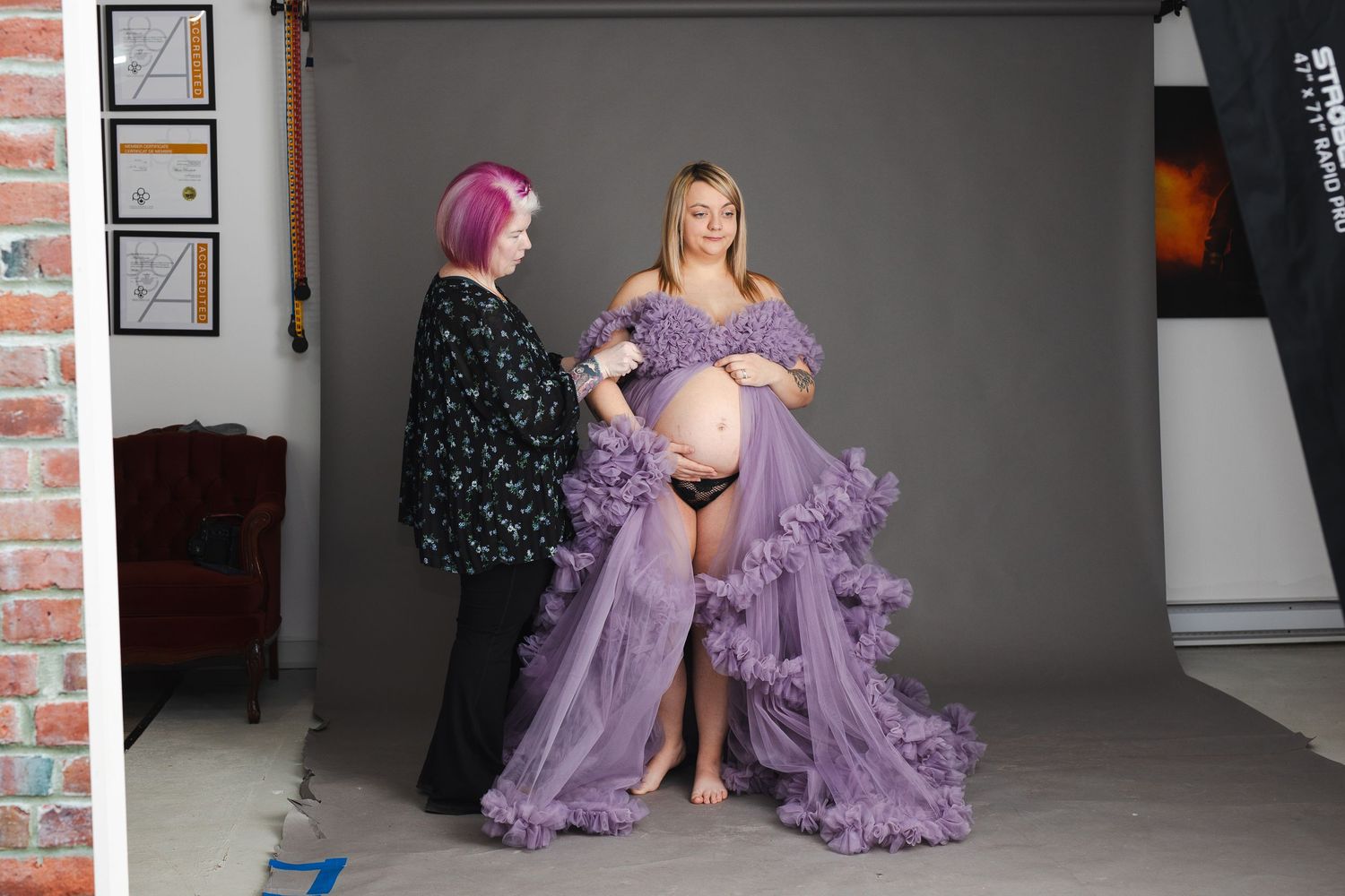 A series of fashion photographs showing a model in a flowing lavender tulle gown posing in a studio setting.