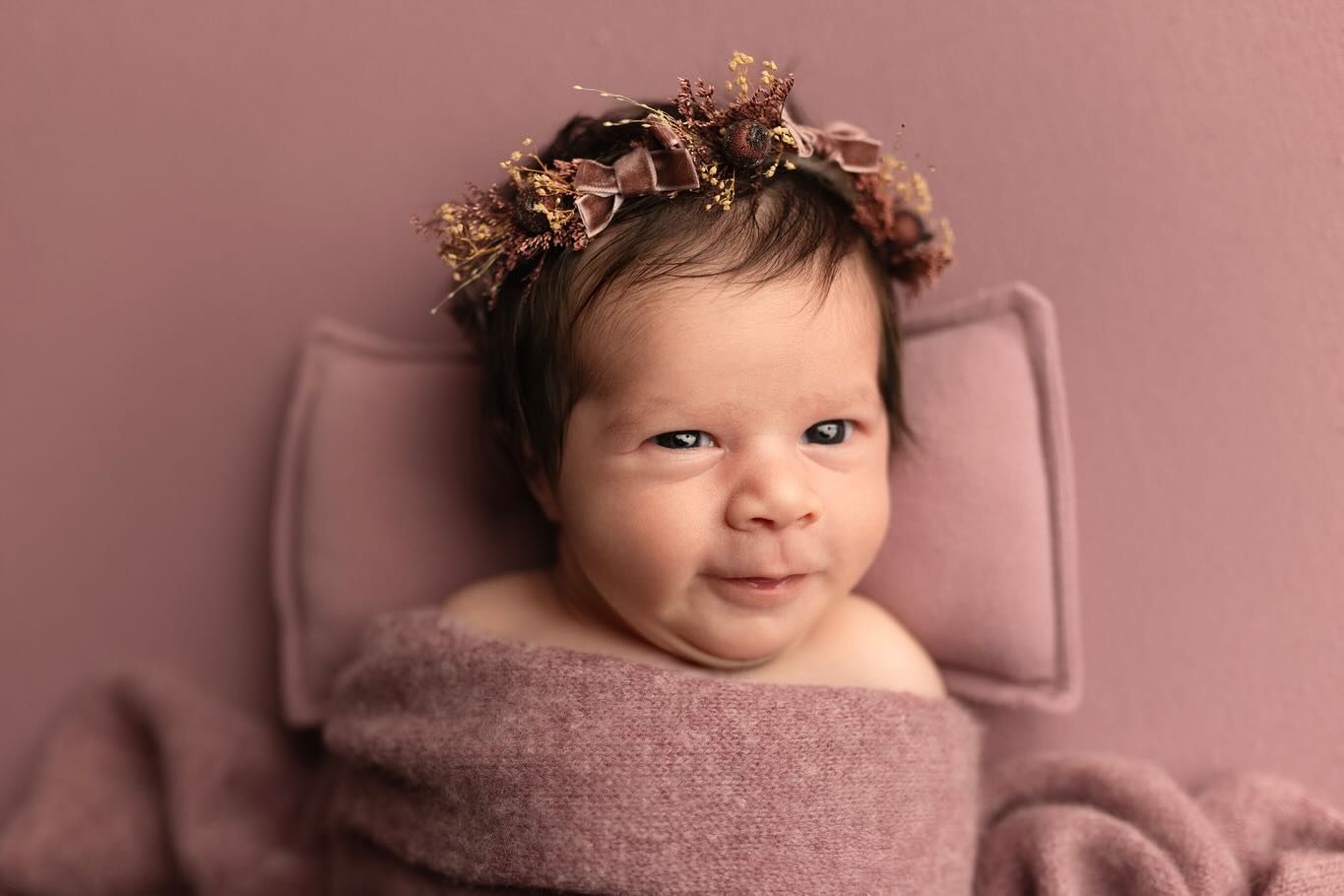 Newborn photography collage with soft pink tones showing sleeping baby wrapped in delicate fabrics and textures.