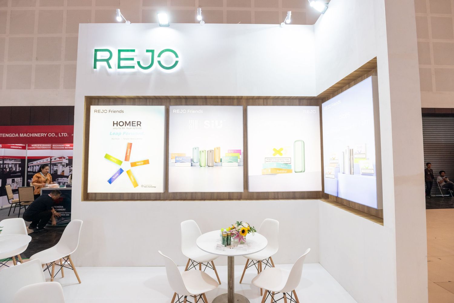 Modern office interior with white walls features minimalist decor and bright lighting throughout the workspace.