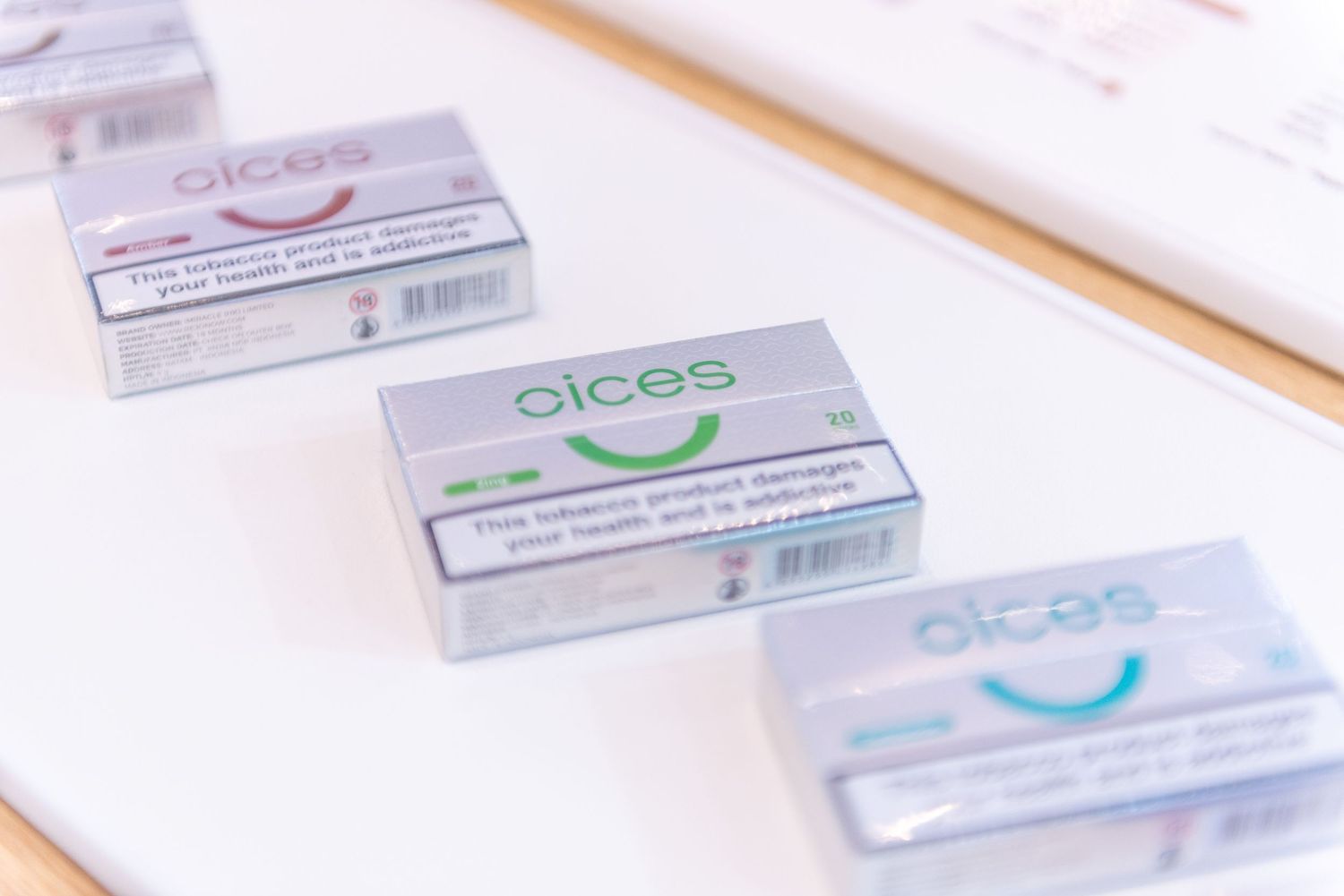 Medical prescription boxes and pharmaceutical packaging arranged in neat rows on a white surface.