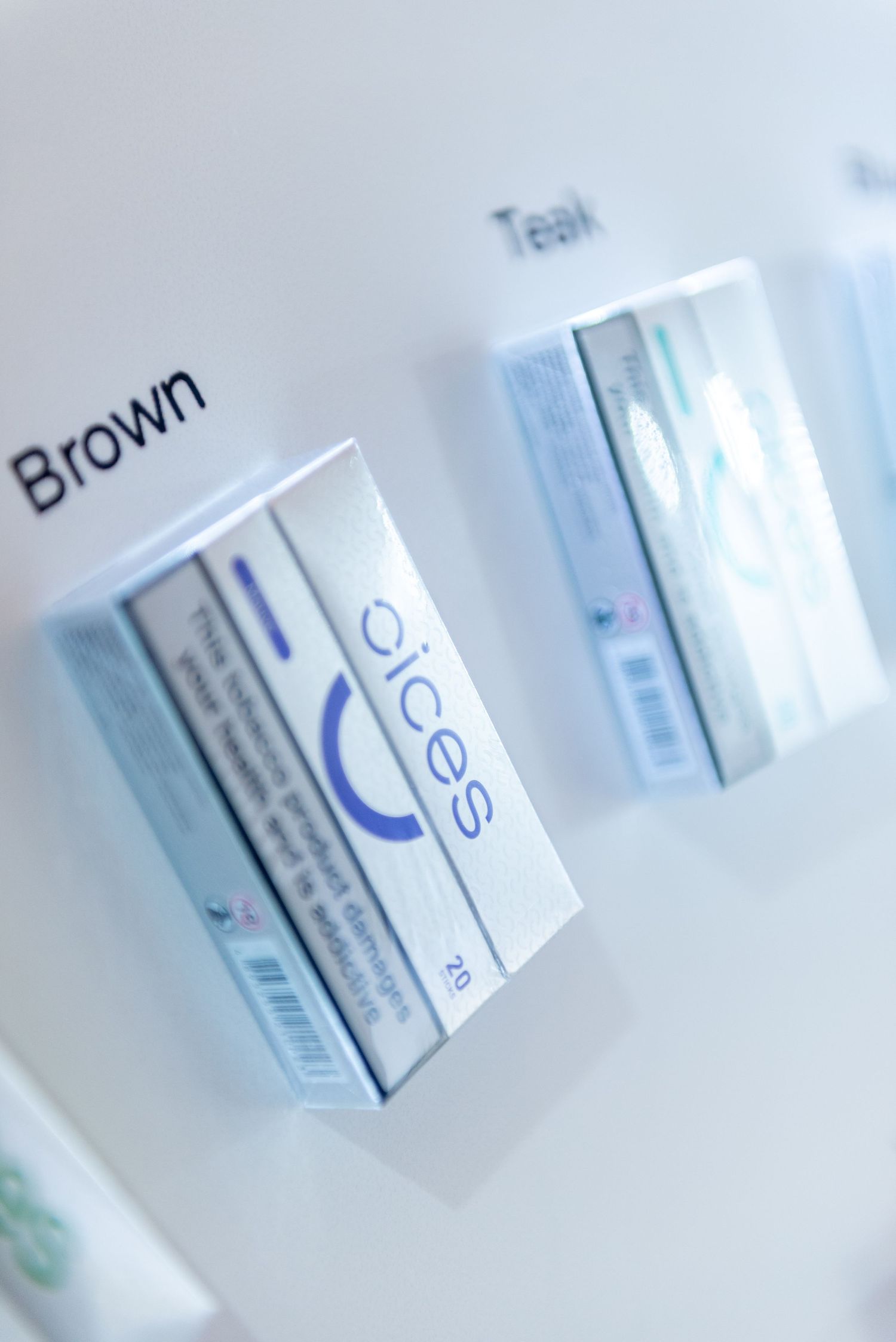 Medical prescription bottles in soft focus arranged in a row showing partial text and blue labeling.