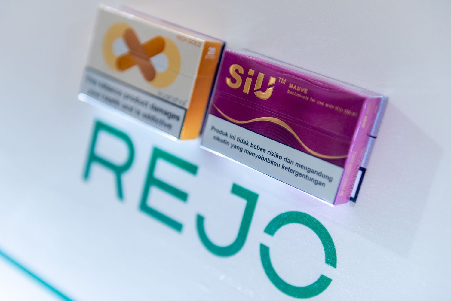 A box of Siu medication sits on a surface with the word 'REJO' written in teal green letters.