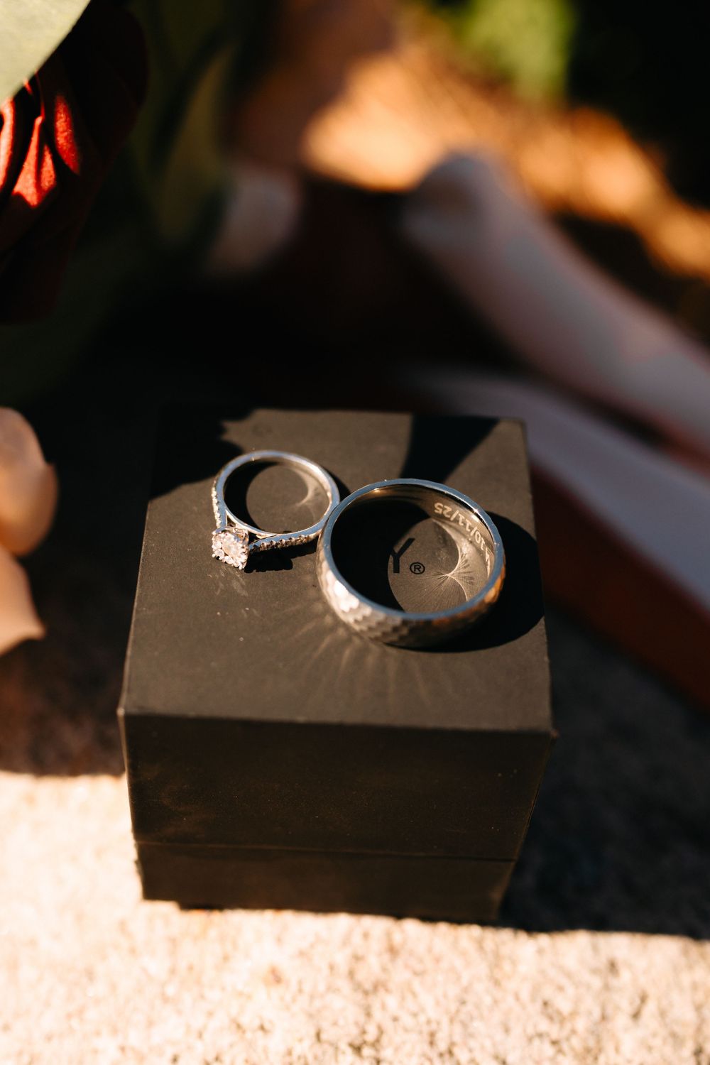 Black wooden ring box photographed from different angles in natural lighting.