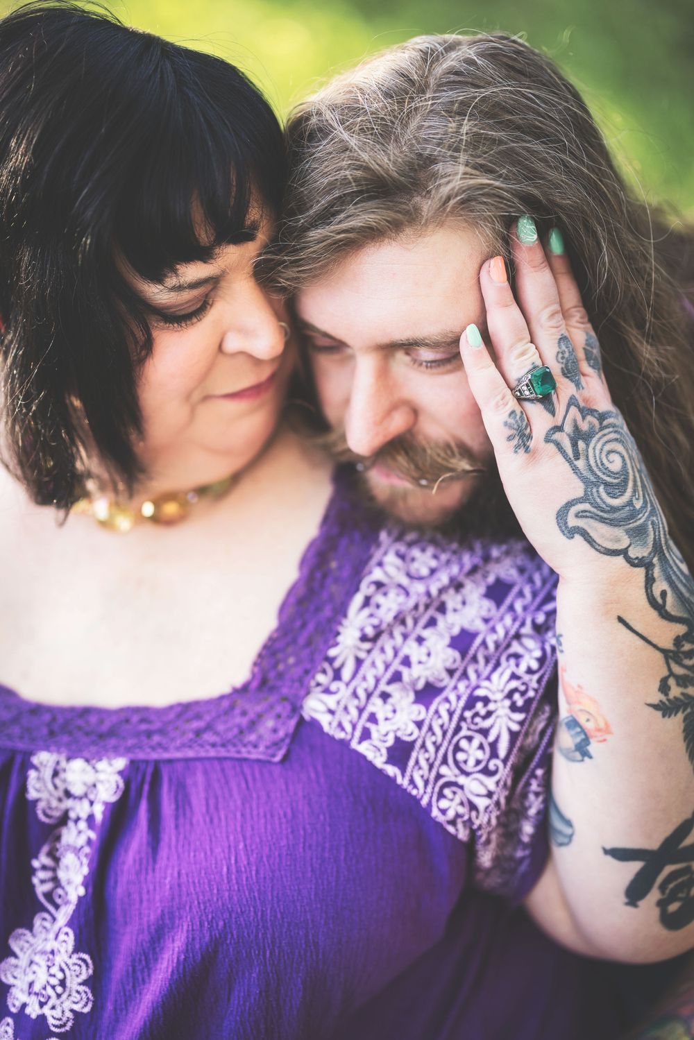 A series of intimate close-up photos showing two people in purple lace clothing with visible tattoos embracing.