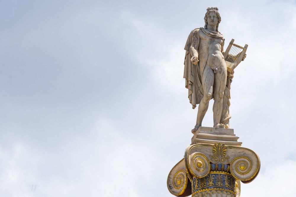 Ancient Greek statues and architectural details are displayed in a row against a light background.