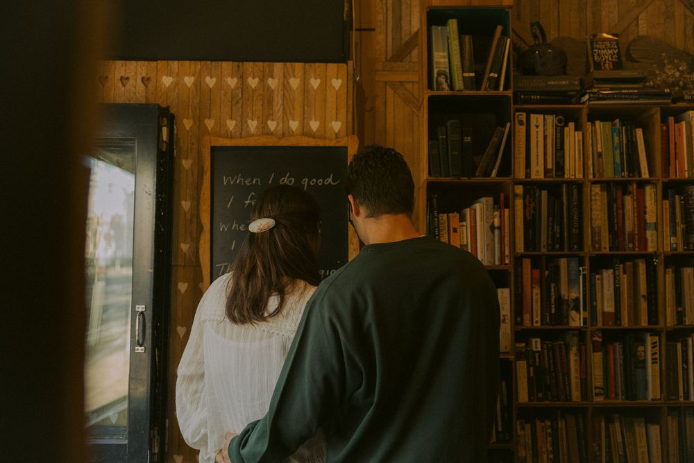 Interior of a charming bookstore cafe with rustic wooden furniture and shelves filled with books.