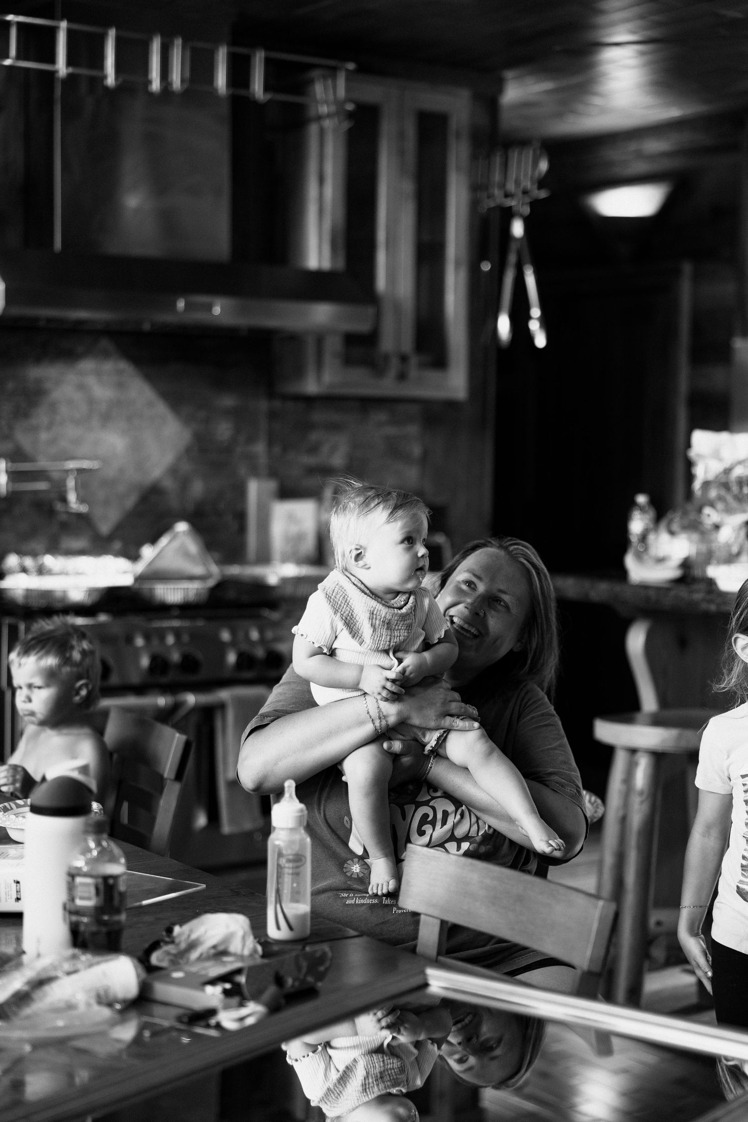 A sequence of black and white photos showing people drinking at a dimly lit bar counter.