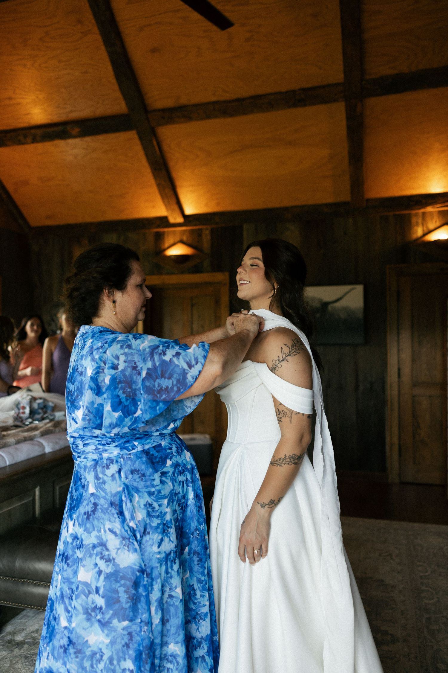Two people in contrasting blue and white dresses share an intimate moment during a wedding celebration.Micro wedding, elopement, intentional