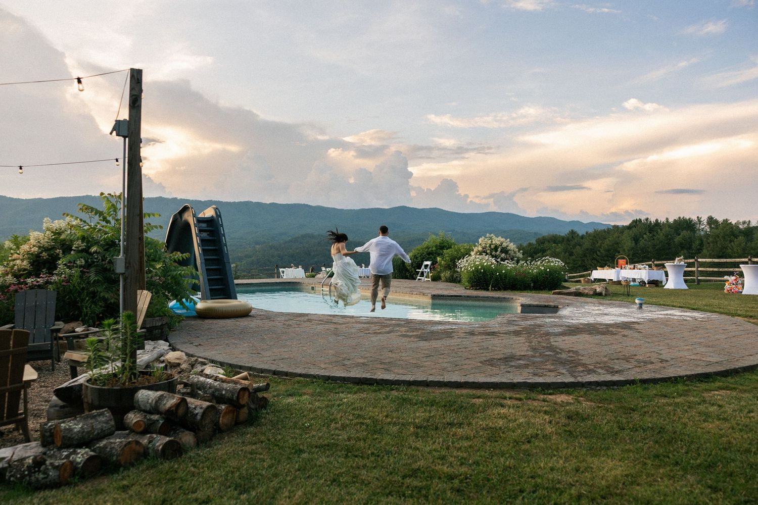 A circular dance floor on a hilltop venue at sunset with string lights and mountain views.Micro wedding, elopement, intentional celebration