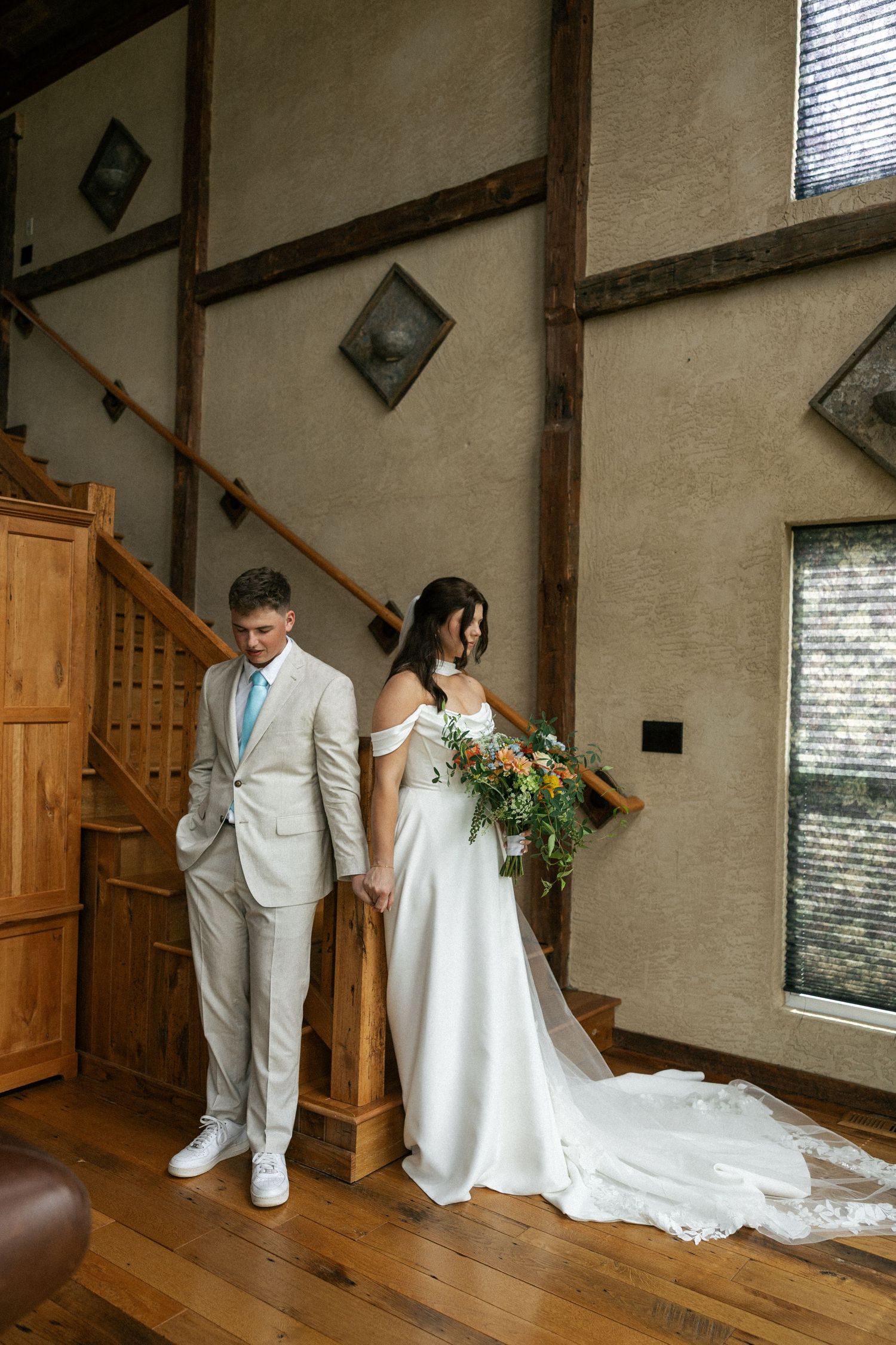 Rustic indoor venue with wooden floors and beams decorated for a wedding ceremony.Micro wedding, elopement, intentional celebration
